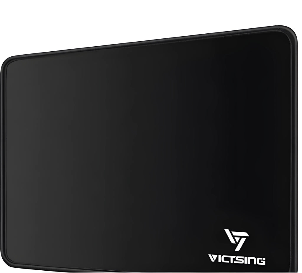 Black rectangular rubber gaming mouse pad on a wooden desk
