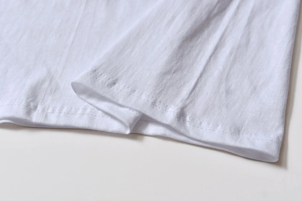 White cotton overalls with round neck and short sleeves in loose pullover style