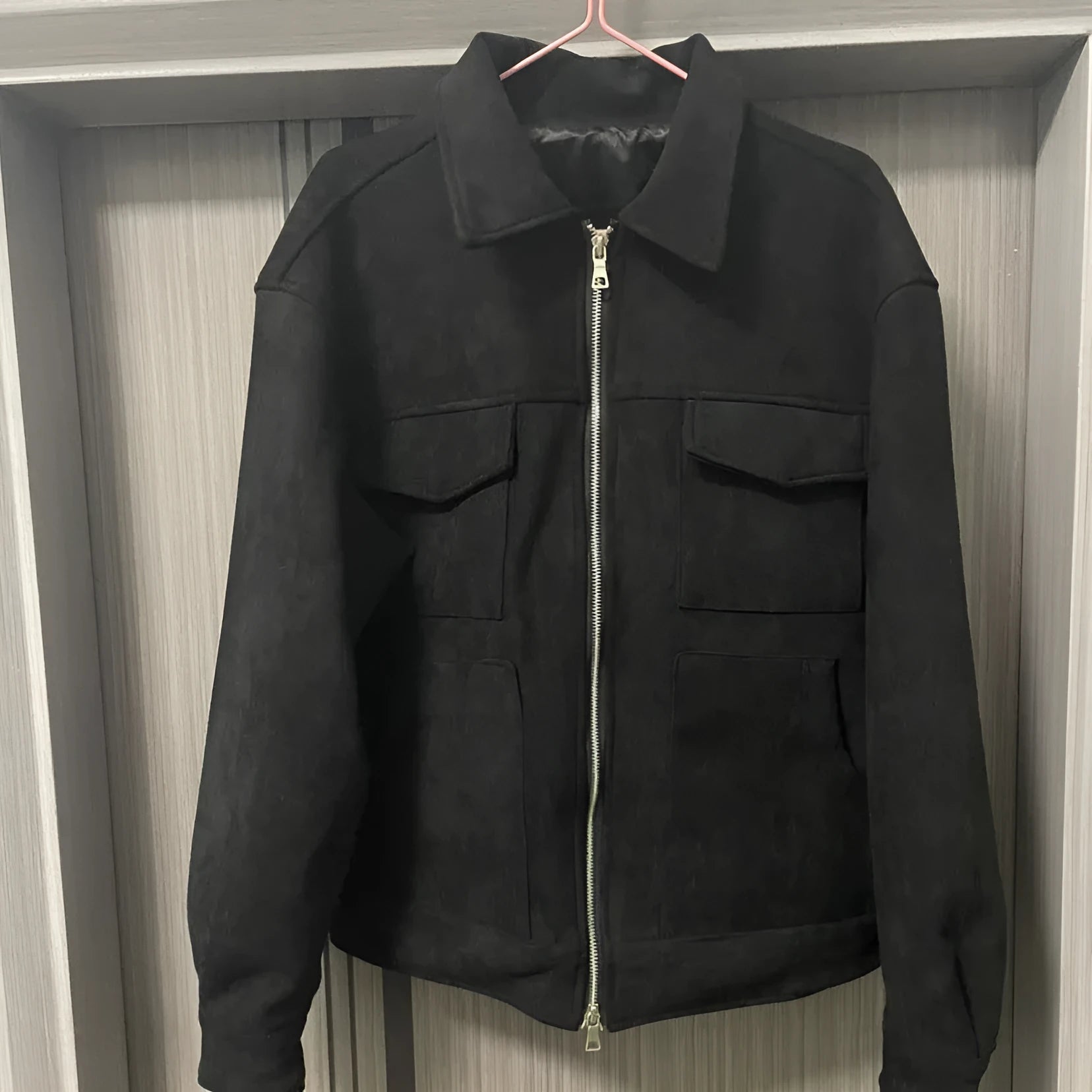 Slim-fit men's jacket with zipper, large pockets, and straight hem in camel, black, or dark grey.