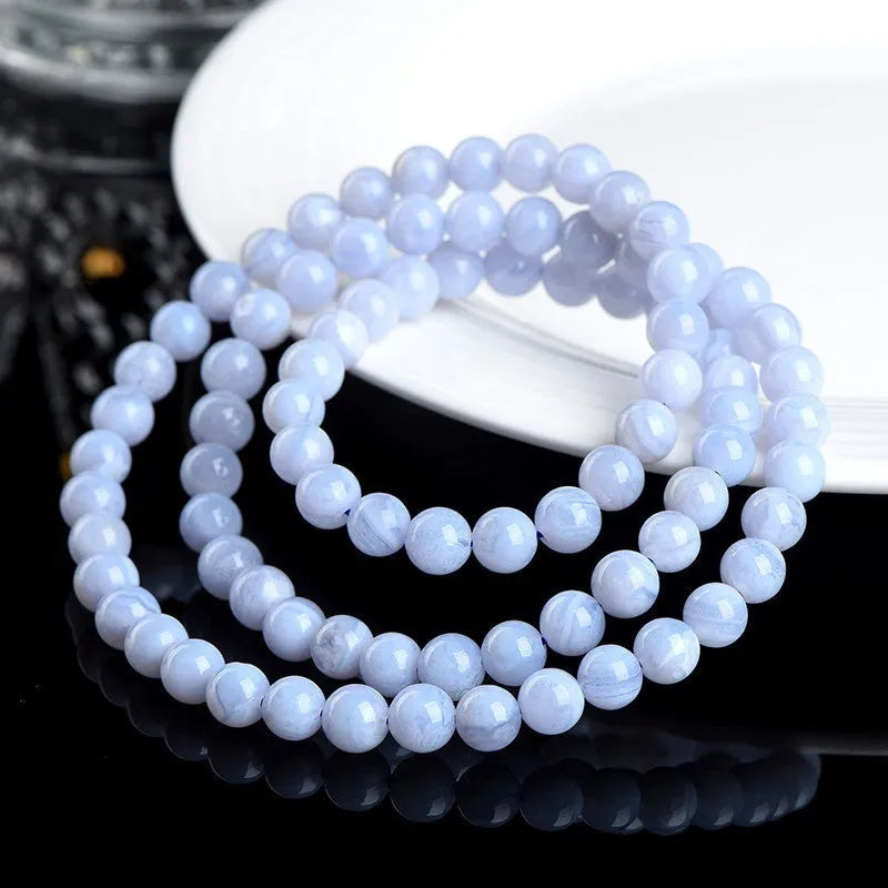 Natural blue agate bracelet with multi-circle pattern and a Ruyi charm.