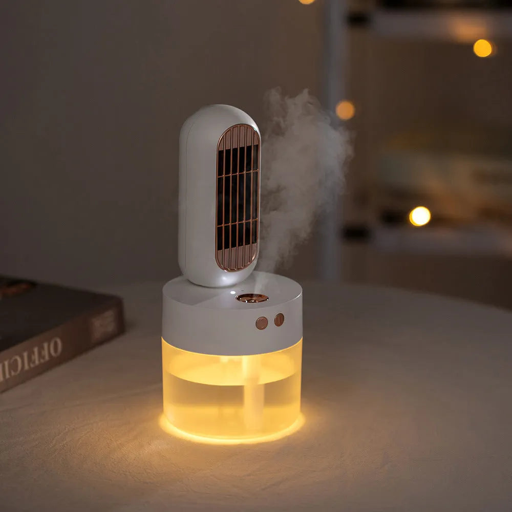 Small black and white humidifier fan with shaking head on a desktop