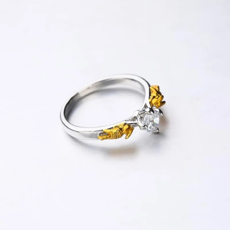 Black gold crystal crown ring on a finger, showing copper metal and decorative stones.