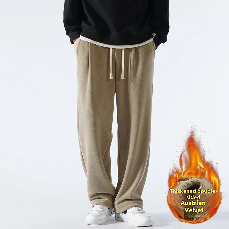 Man wearing apricot coloured double-sided polar fleece winter trousers with a loose fit and drawstring waist.