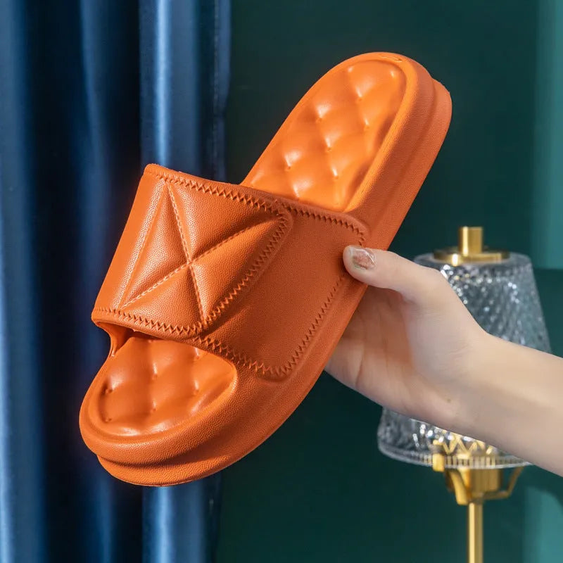 A pair of soft EVA couples bath sandals with a thicker sole, shown in a choice of colours on a bathroom floor.