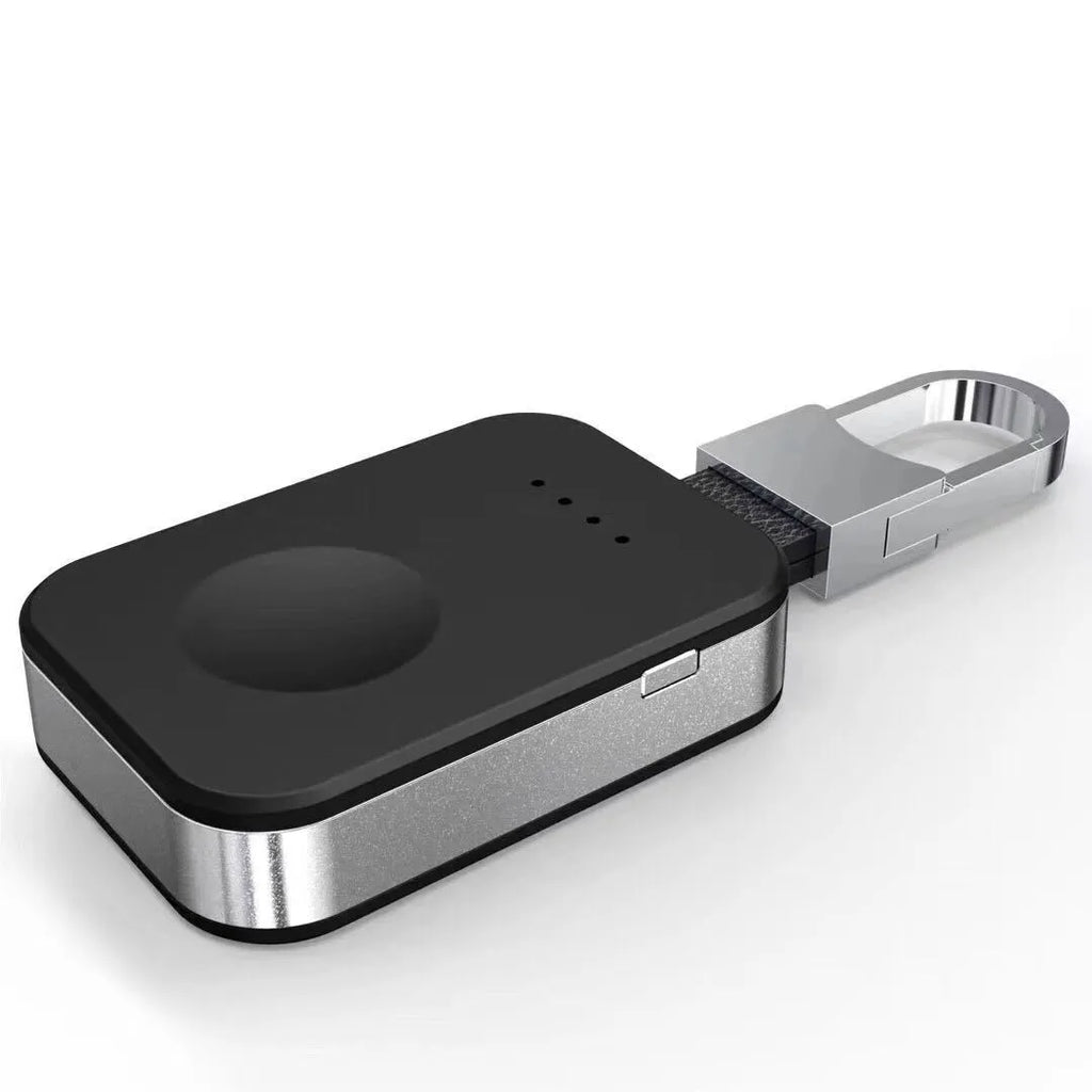 Black keychain-sized wireless power bank for Apple Watch on a keyring.