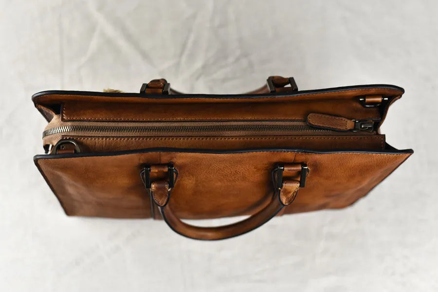 Men's black leather horizontal handbag with zipper opening showing 14-inch size.