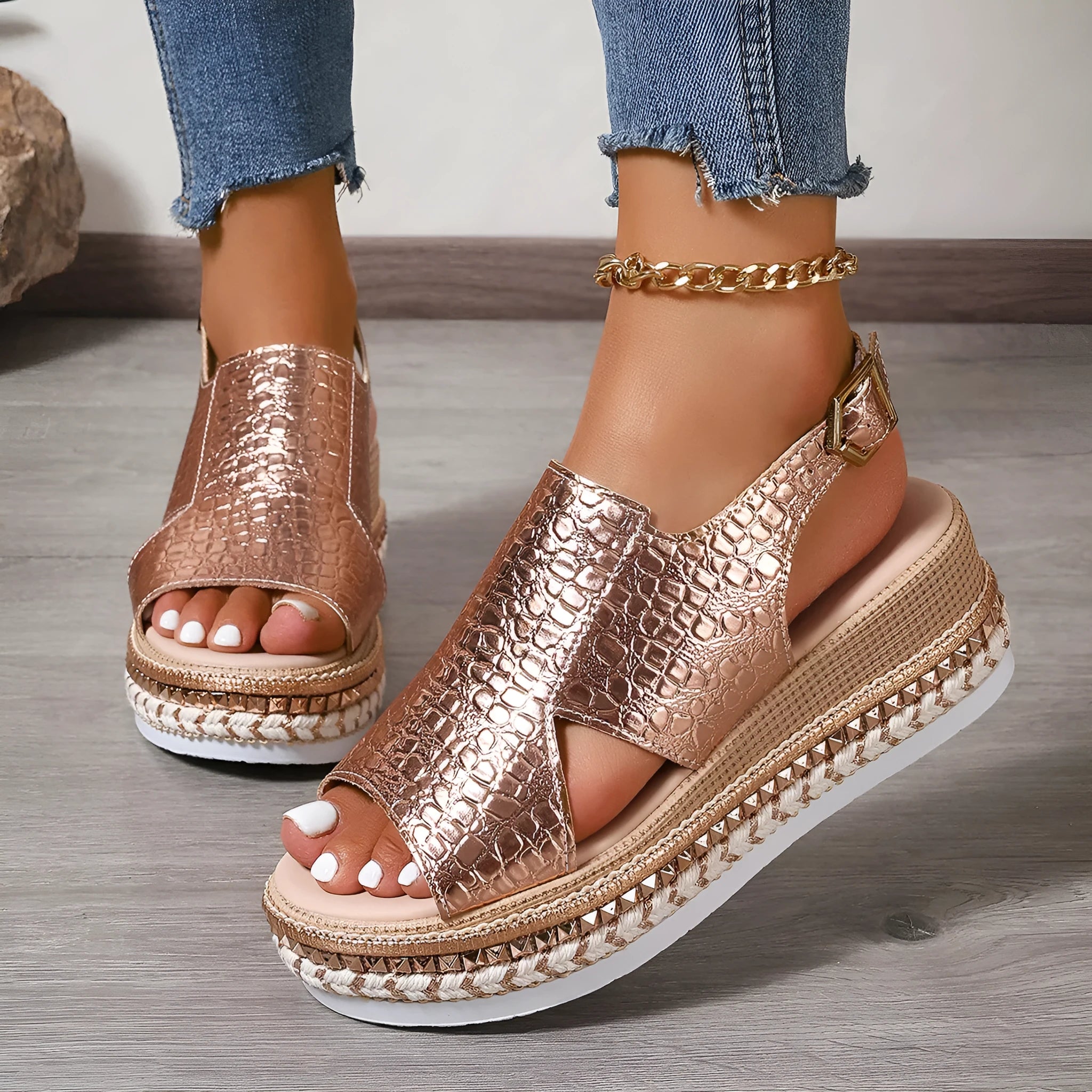 Gold women's Roman sandals with round toe, hollow-out upper, and an ankle buckle.