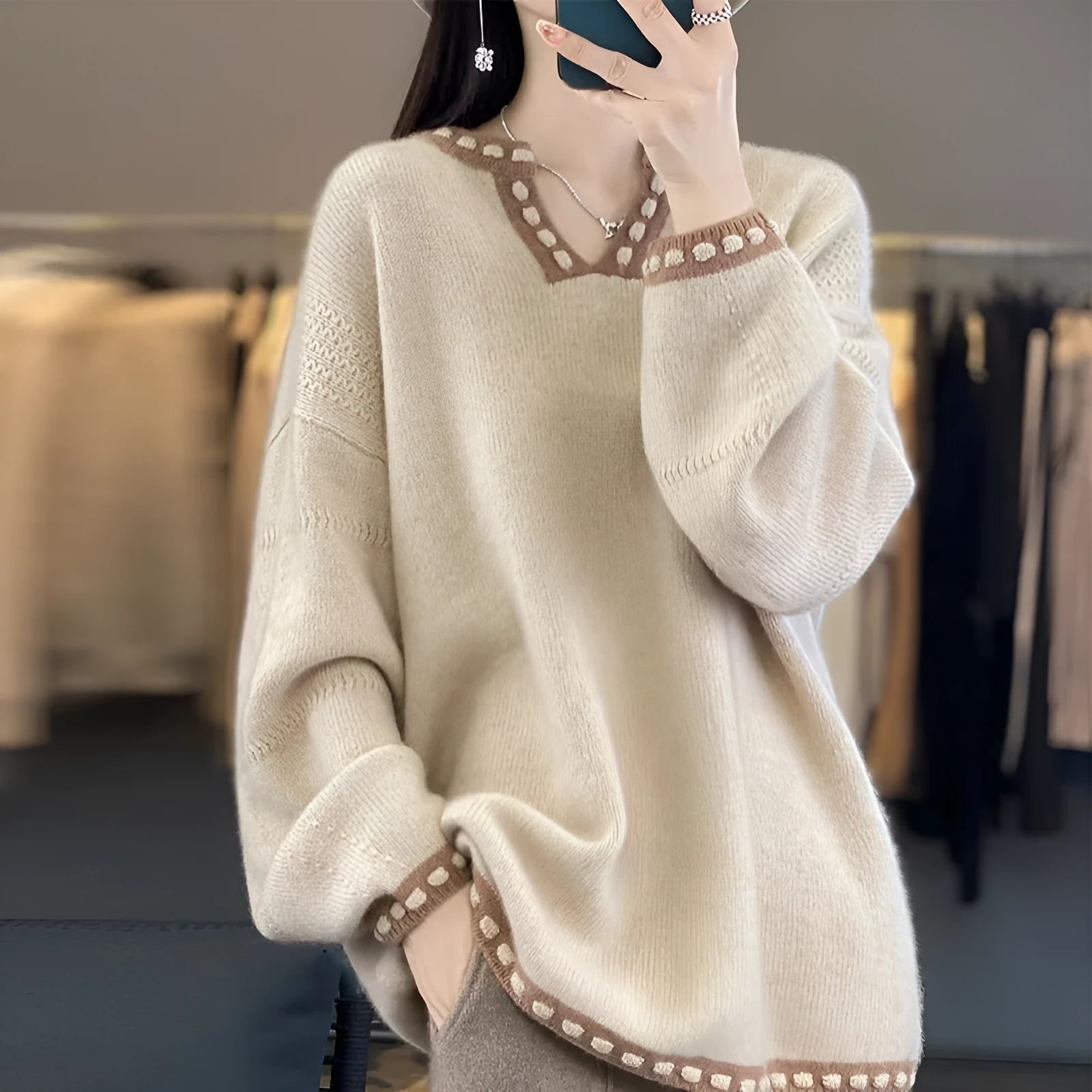 Women's white V-neck pullover sweater with regular long sleeves showing front view
