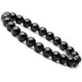 Close-up of a black agate bracelet with 8mm geometric beads on a black elastic cord.