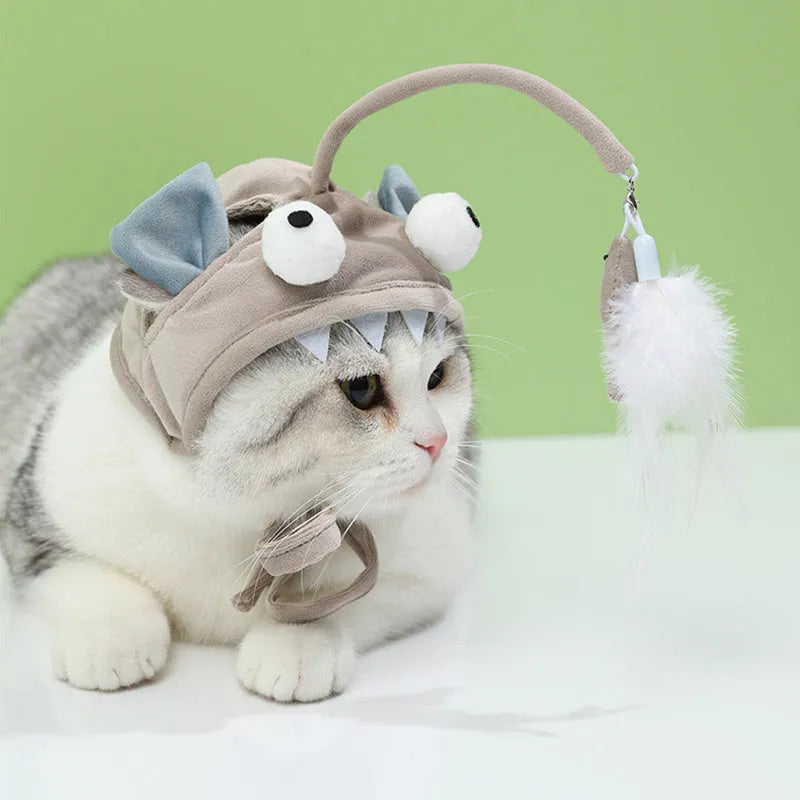 Grey cat teaser toy with adjustable headband, feather decoration, and big eye fish design