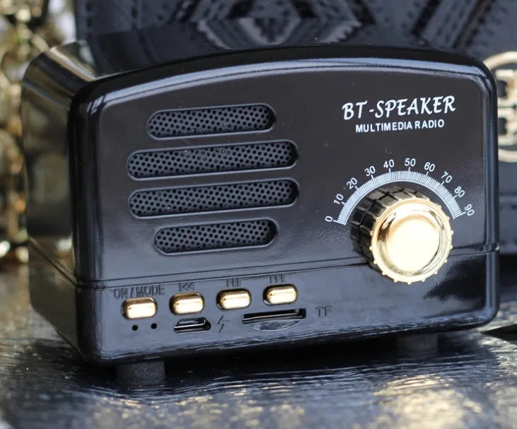 Compact portable Bluetooth speaker with a vintage wood grain finish on a plastic shell