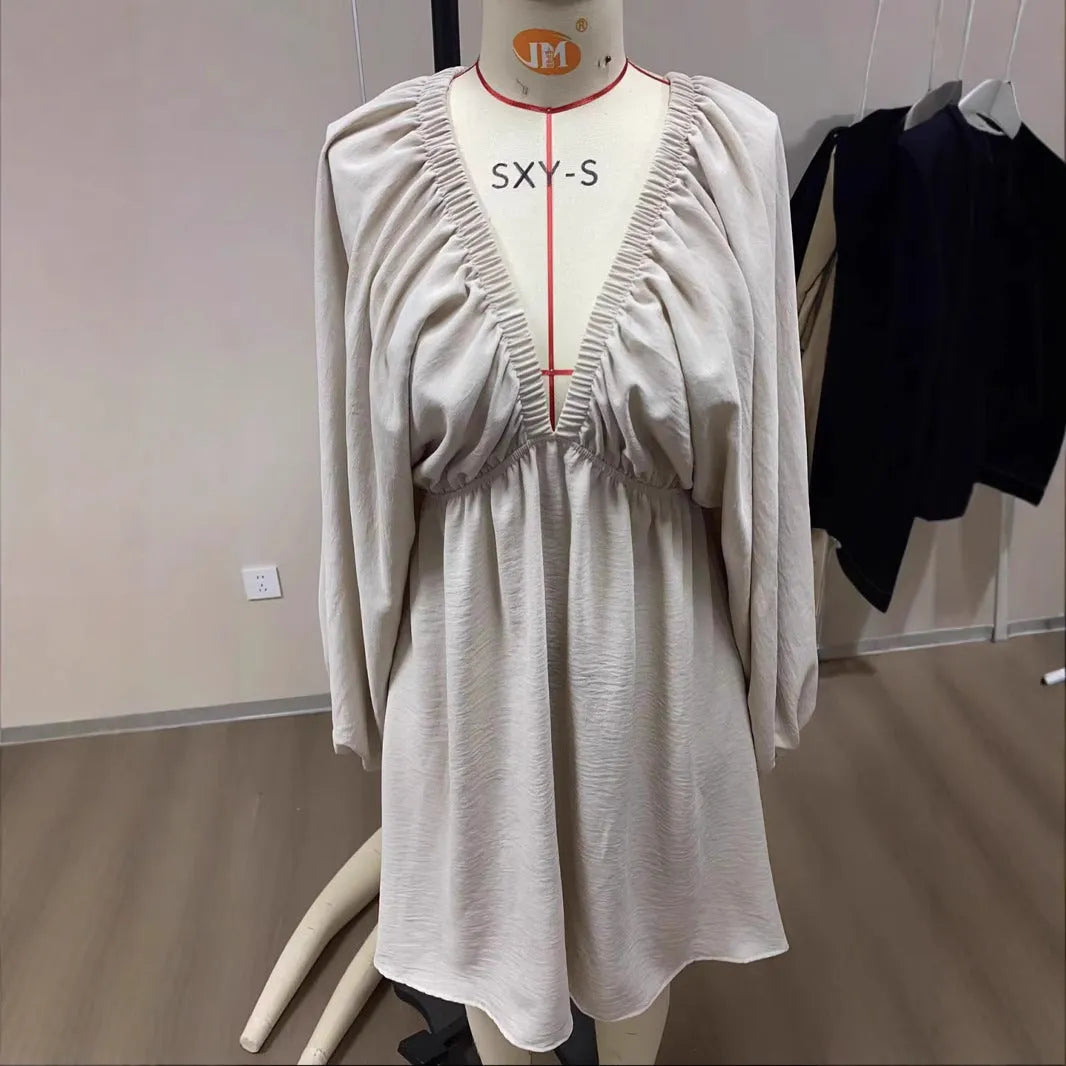 Women's apricot V-neck midi dress with long puff sleeves and a flounced skirt.