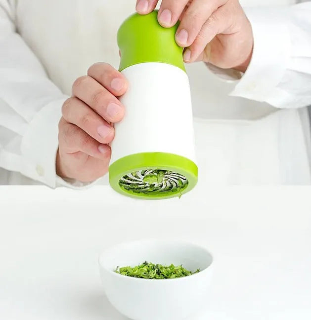 Manual PP plastic herb grinder with stainless steel blades and a removable top, shown upright.