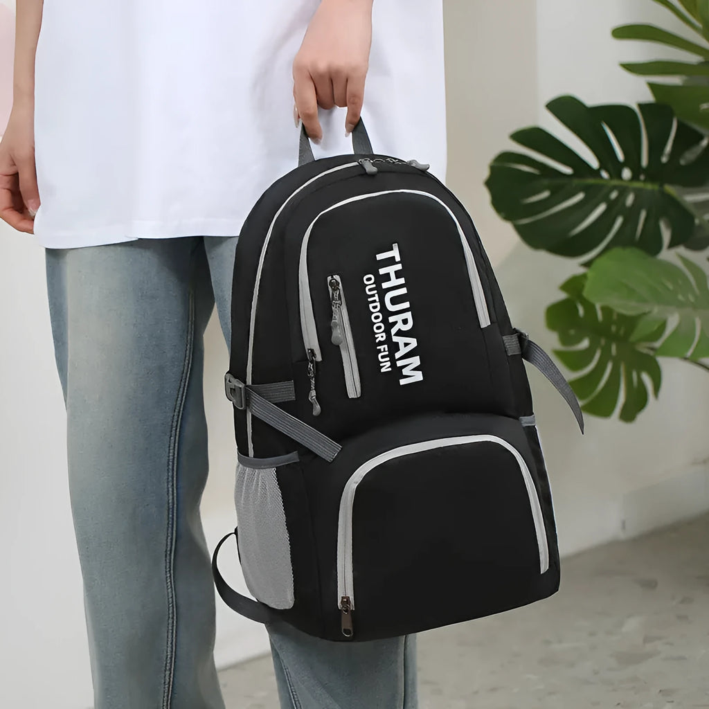 Outdoor folding rucksack in dark blue with air pillow belt system showing 20-35 litre capacity