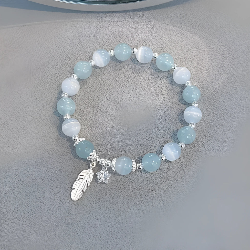 Glass crystal bracelet with coloured glaze in blue moonlight colour showing text modelling and eight-point star detail