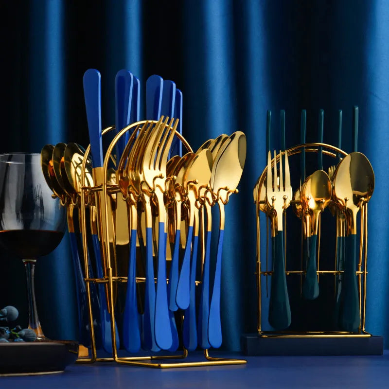 Gold 24-piece stainless steel cutlery set with knives, forks, spoons, and a storage rack.