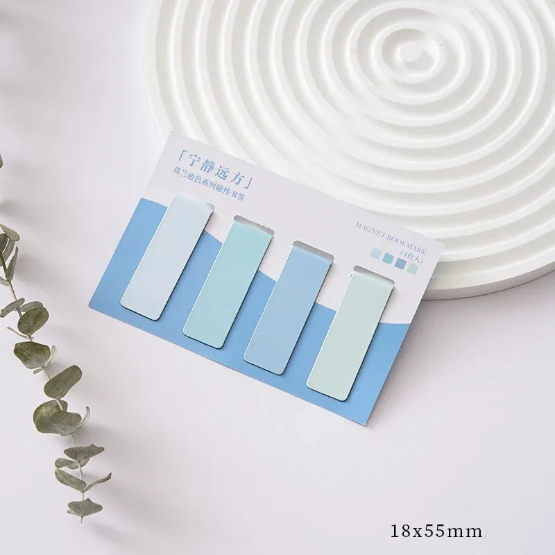 Set of four pastel colour block magnetic bookmarks from the Morandi series on a book page.