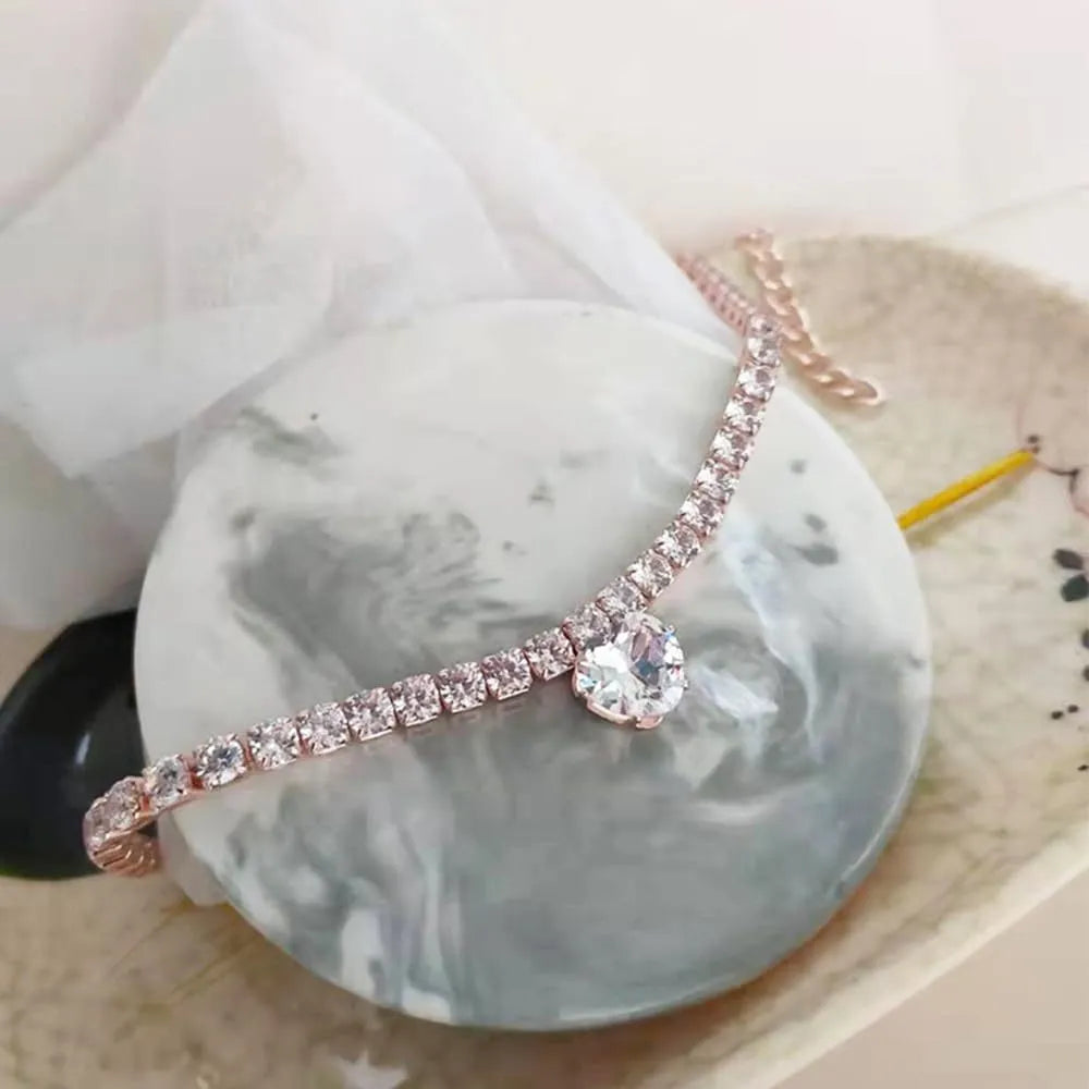 Gold rhinestone heart-shaped decorative collar for cat or dog on a white background.