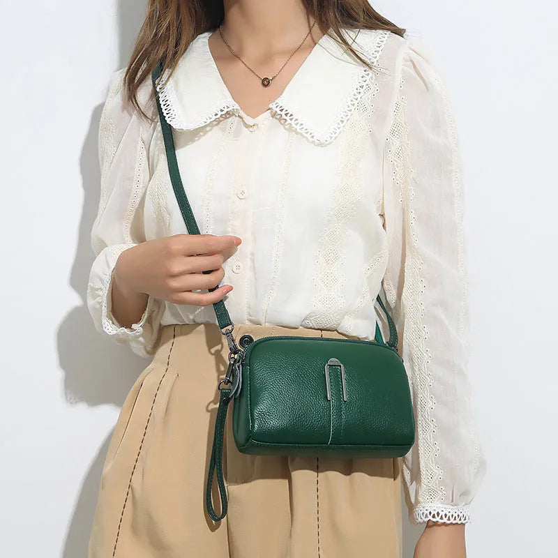 Women's black genuine leather shoulder bag showing square shape and compact 19x13x6cm size