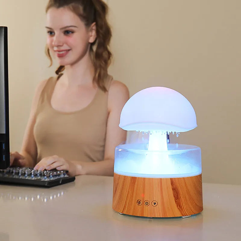 White cloud-shaped humidifier with simulated falling raindrops and coloured LED lighting