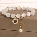 White Korean-style geometric bracelet with a cat's eye crystal on a stretch elastic band.