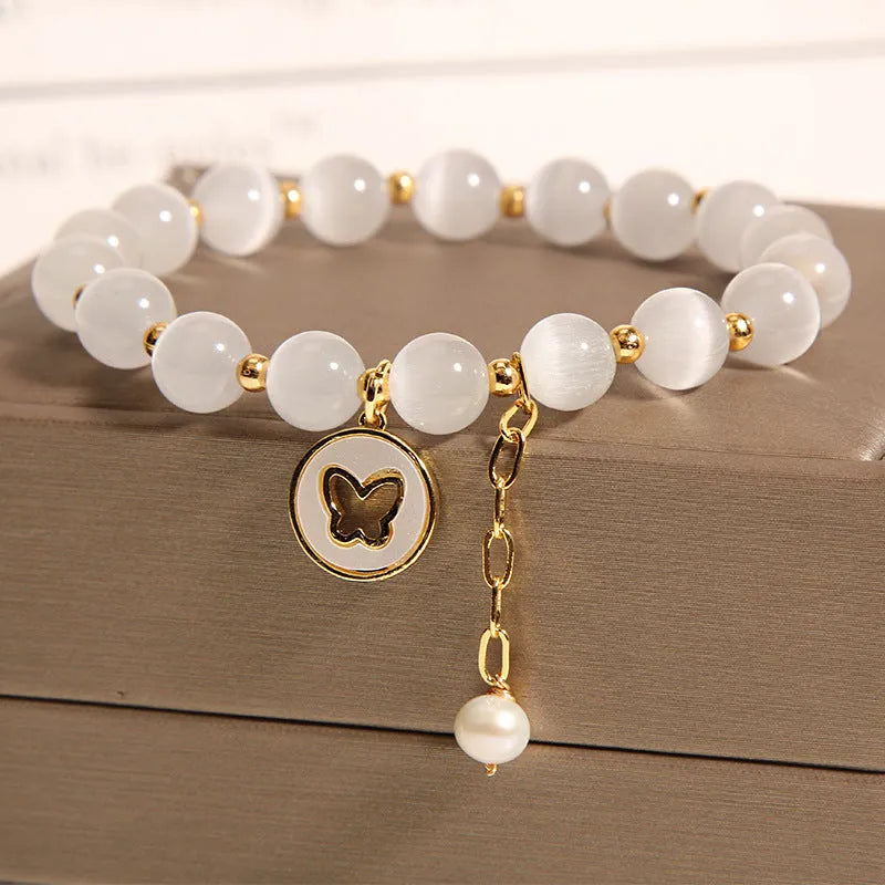 White Korean-style geometric bracelet with a cat's eye crystal on a stretch elastic band.