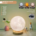 Rotating moon night lamp with wooden base showing three colour modes