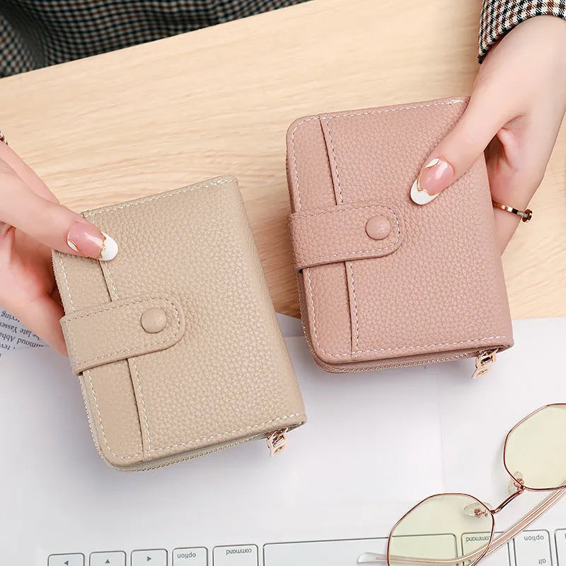 A ladies' short folded wallet with a lychee pattern, shown in beige, pink, black, and red colour options.