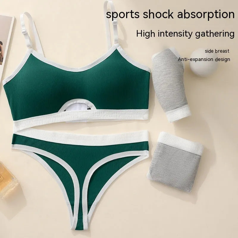 Women's black sports bra and panty set with underwire, moulded cups, and contrast colour back detailing.