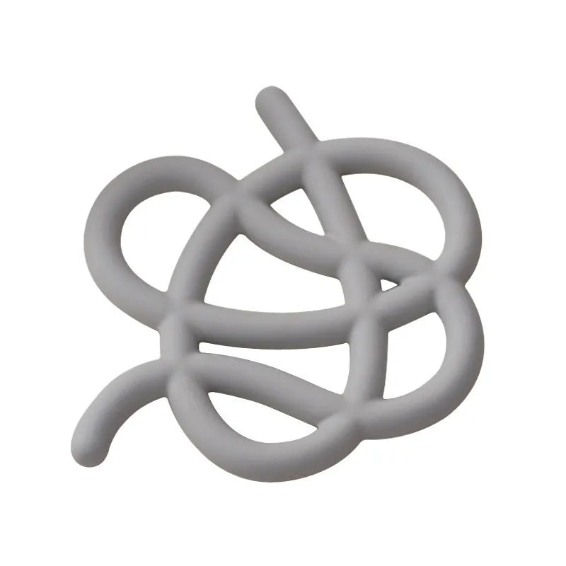 A solid colour ceramic heat proof mat with an irregular shape on a dining table.