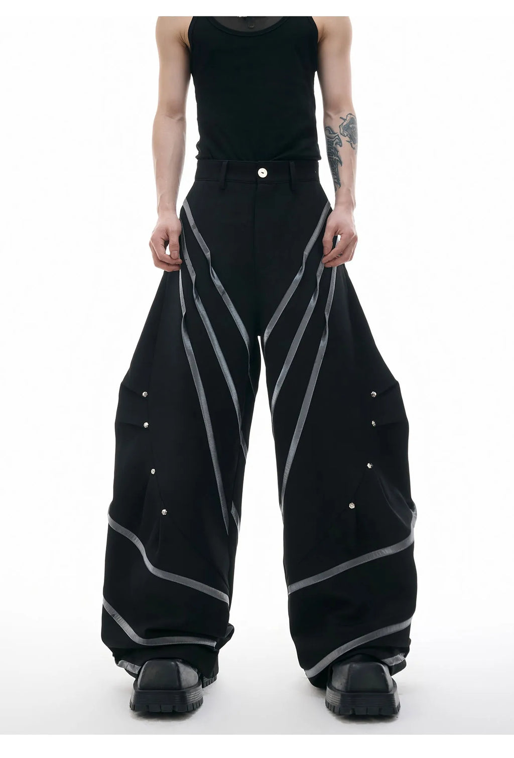 Men's black trousers with three-dimensional cut, metal striped rivets, and pleated detailing