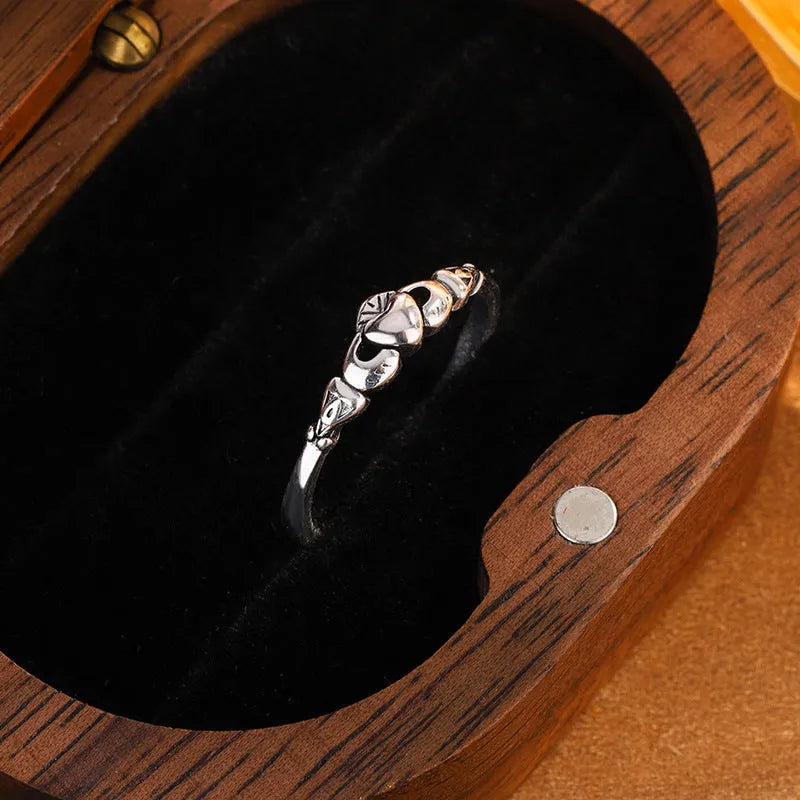 Retro silver heart open ring on finger showing adjustable copper construction and heart silhouette