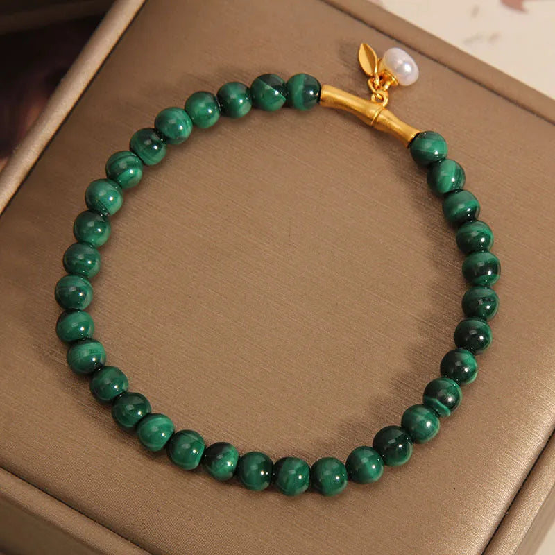 Women's white crystal lucky bamboo bracelet with adjustable clasp on a wrist.
