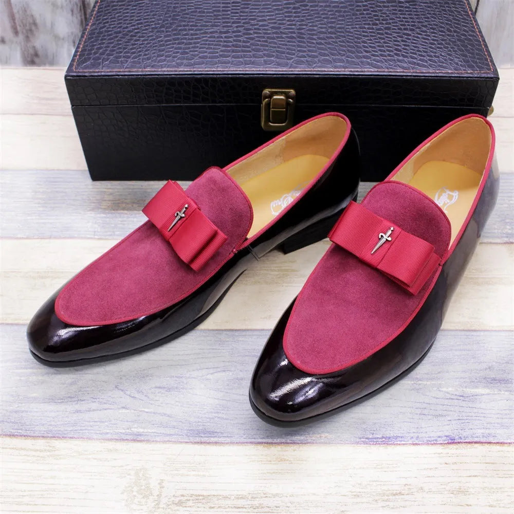Men's black low-top leather brogue shoes with a patent leather finish and tassel detail on a rubber sole.