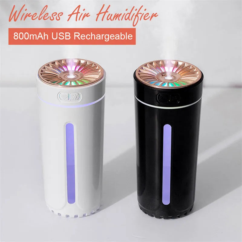 Black portable ultrasonic humidifier with colourful LED lights on a car cup holder.