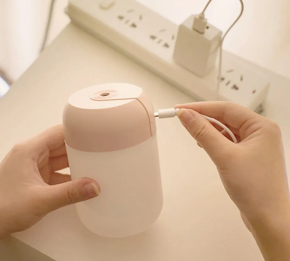 Small white cylindrical USB humidifier with aromatherapy function on desk