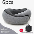 U-shaped navy blue travel neck pillow with memory foam, shown rolled up next to its carry bag.