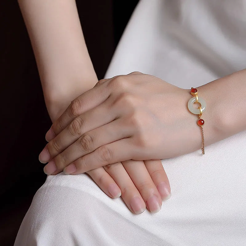 Gold-plated S925 sterling silver bracelet with inlaid natural Hetian jade stone and adjustable peace buckle clasp.