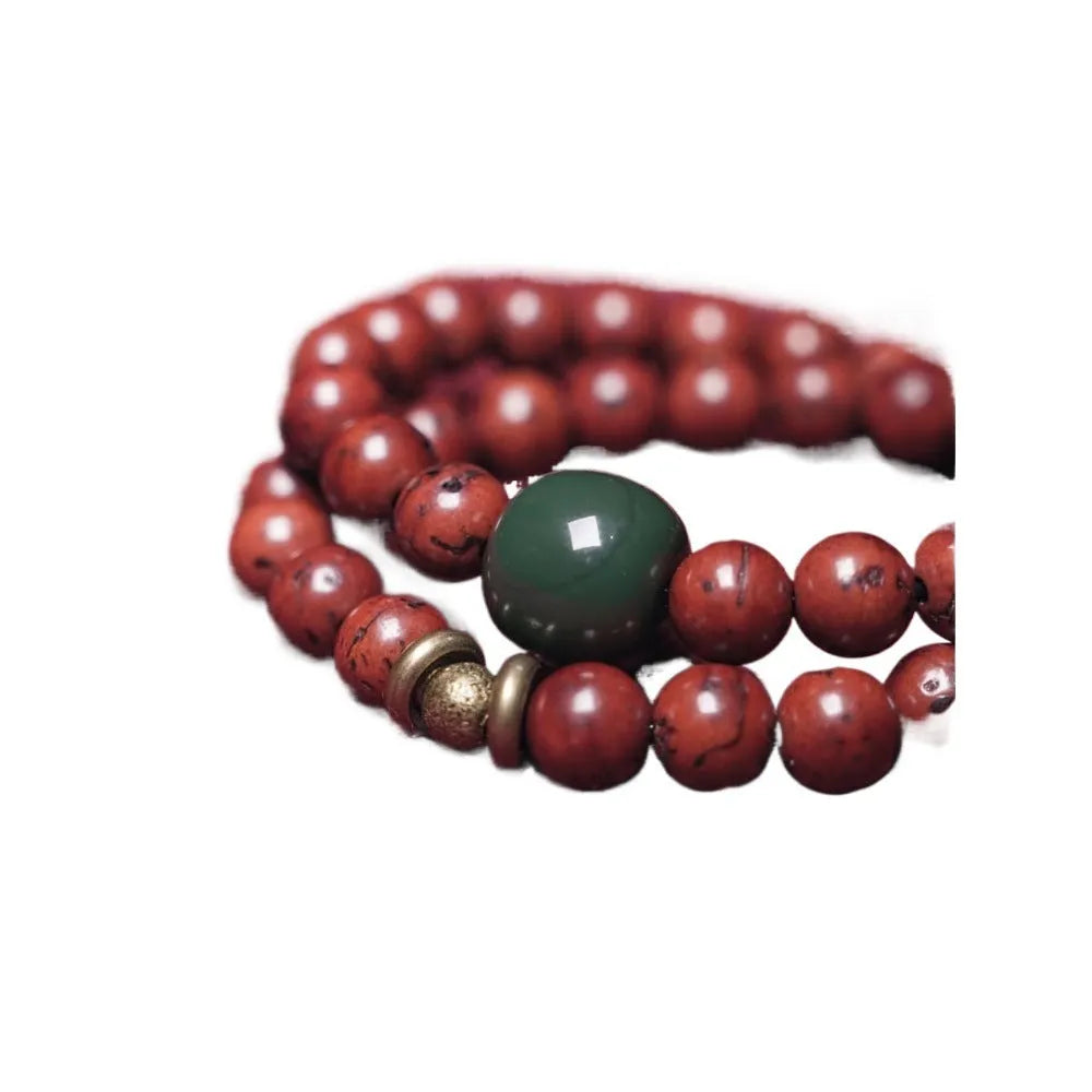 Handmade bodhi seed double circle bracelet with cartoon style on a wrist.
