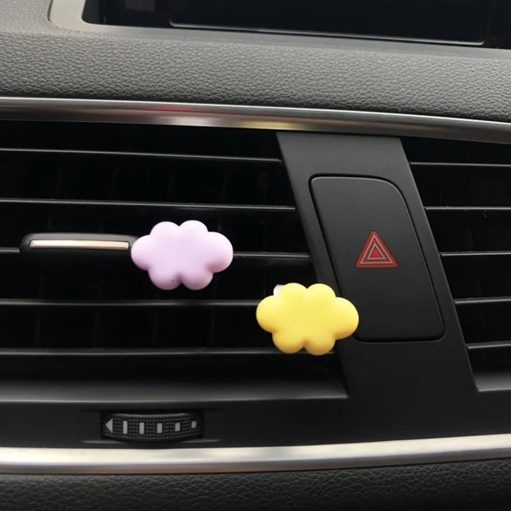 Resin Baiyun cartoon car fragrance clip in light green colour attached to a car air vent