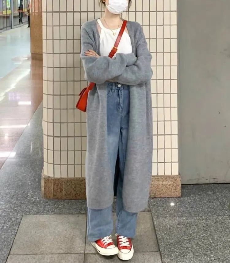 Women's khaki knitted V-neck cardigan with long sleeves, shown on a model.