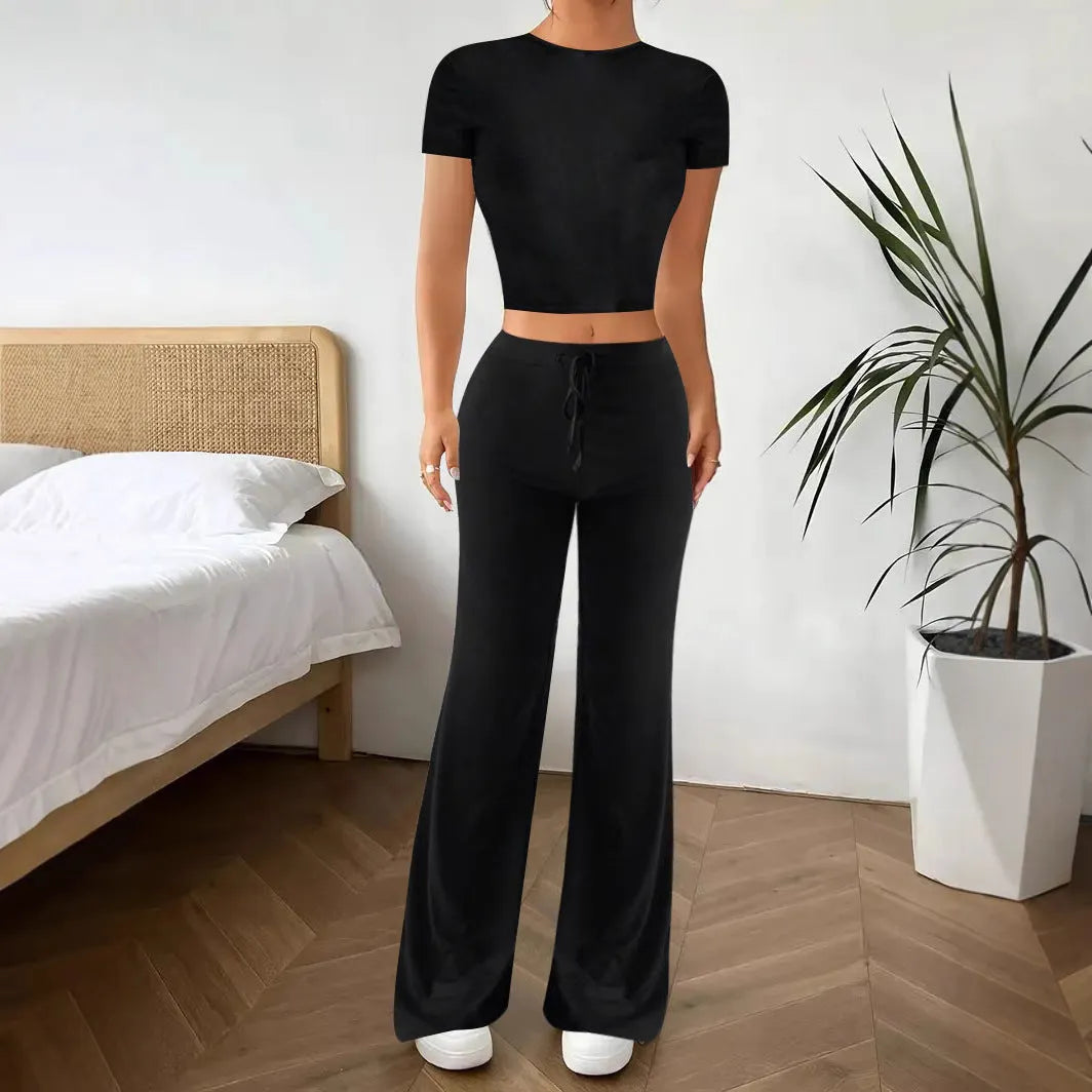 Black high waist trousers and short sleeve t-shirt co-ord suit set on a hanger.