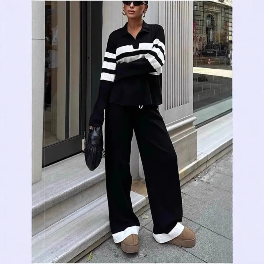 Women's black and white striped knitted two-piece set with a polo collar, featuring a long-sleeve top and trousers.