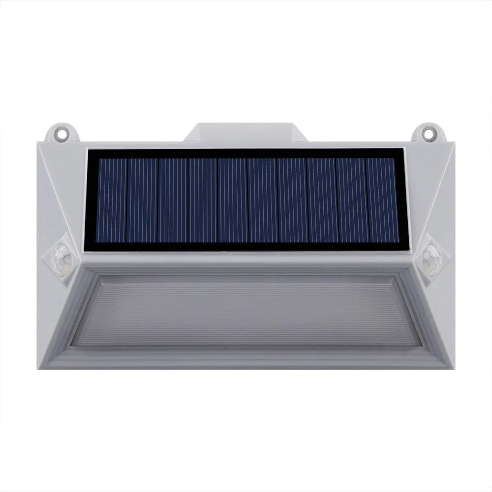 Solar-powered outdoor step light with motion sensor in abstract design on a brick step.