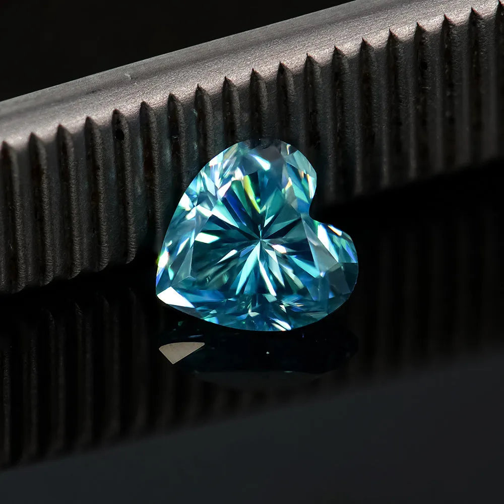 Colourful heart-shaped moissanite gemstones in red, blue, yellow, and pink for jewellery making.