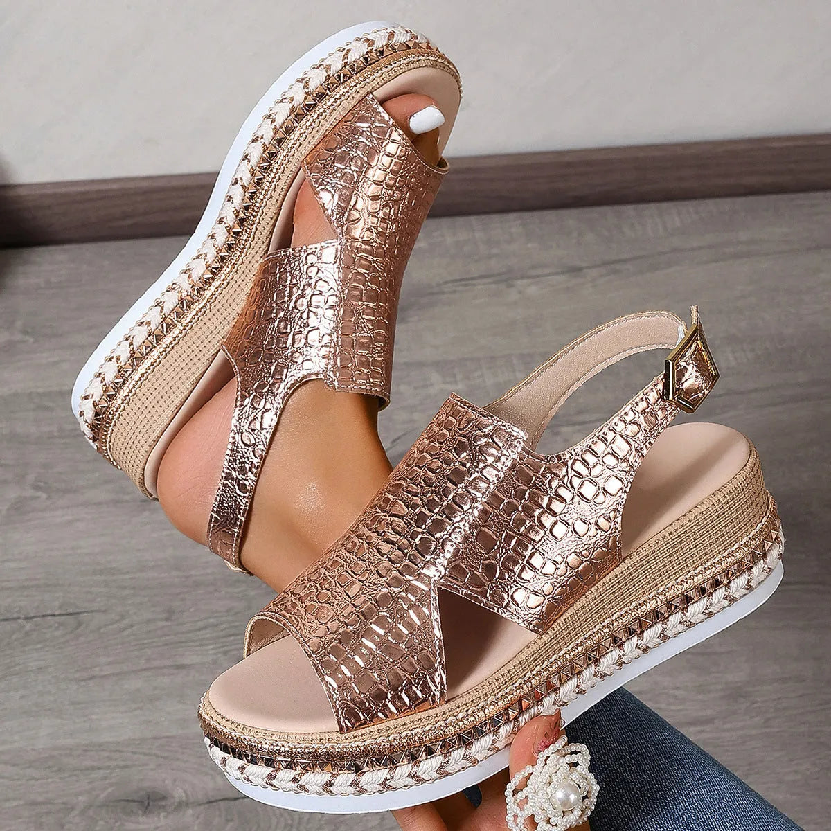 Gold women's Roman sandals with round toe, hollow-out upper, and an ankle buckle.