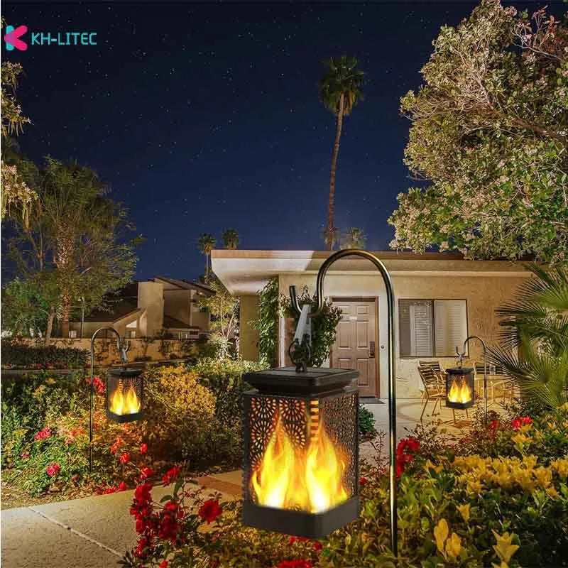 Set of four black solar-powered hanging lanterns with flickering flame LED light for outdoor garden decoration.