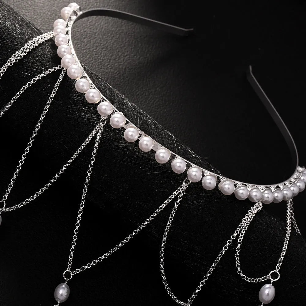 Gold electroplated mesh hair chain for women with pearl beads and a dangling tassel detail.
