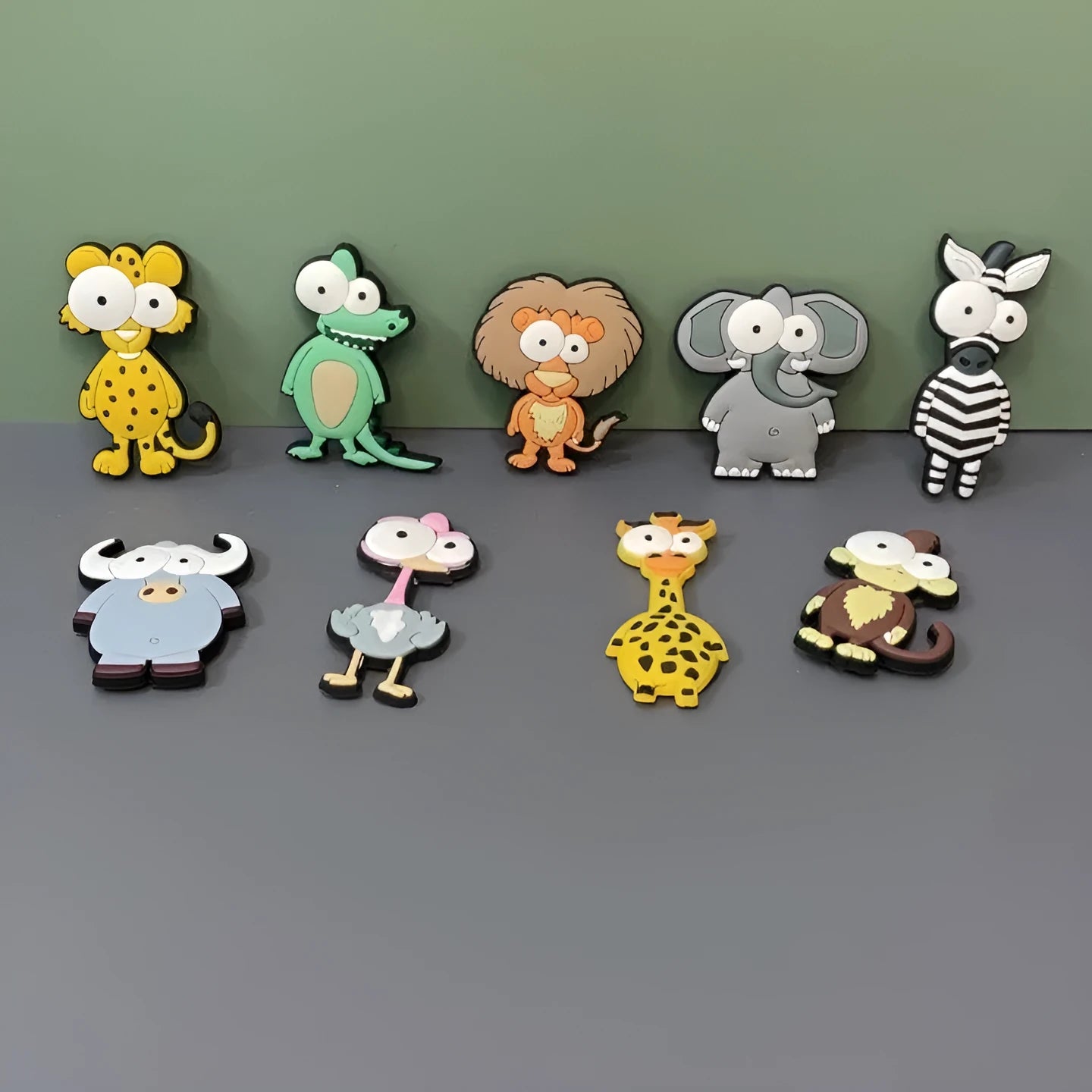 Set of 9 PVC cartoon animal refrigerator stickers with safari animals including monkey, lion, and giraffe on a white fridge door.