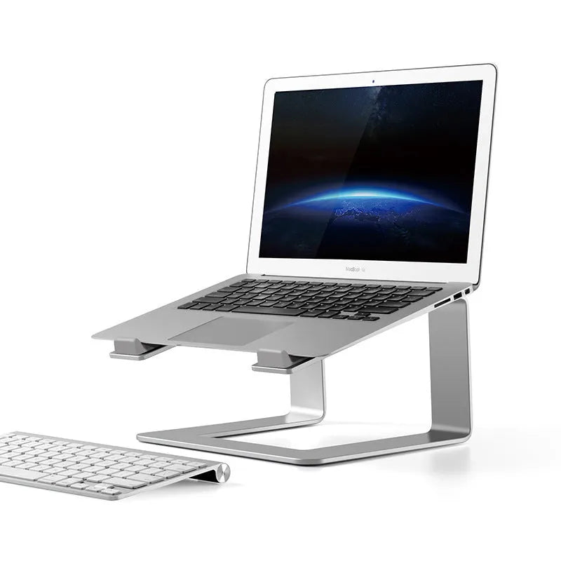 Black aluminium laptop stand with angled platform on a wooden desk